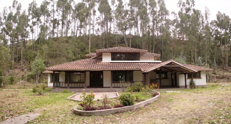 The front of the house before the work, with an open carport on the right-hand end