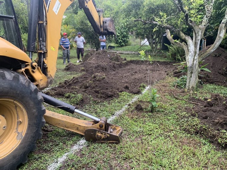 Excavating the lap pool with a backhoe